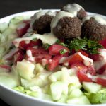 Falafel, tahini and salad in a bowl