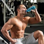 Muscular Man Drinking Water to Stay Hydrated