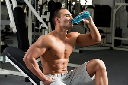 Muscular Man Drinking Water to Stay Hydrated