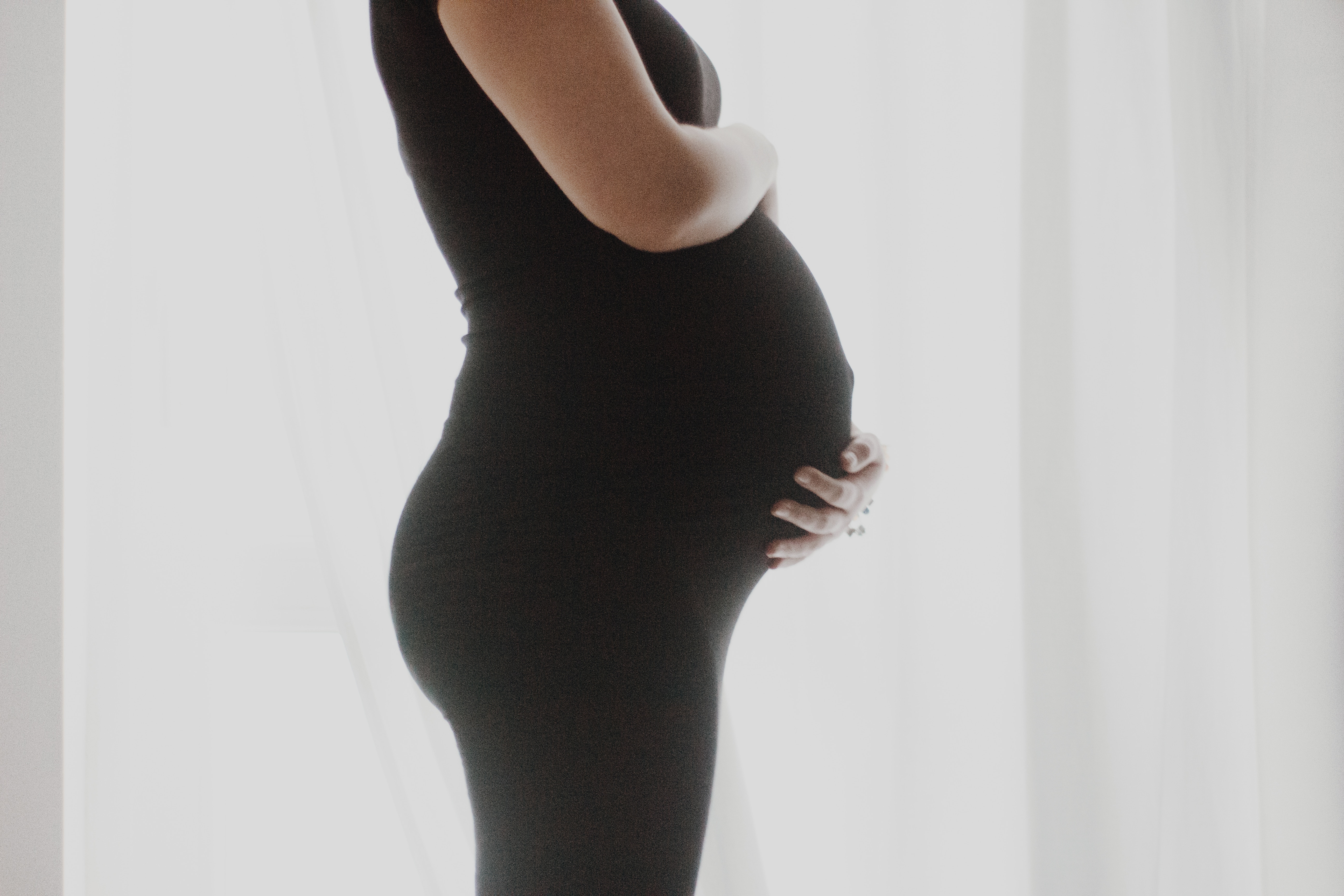 Pregnant woman wearing black pants
