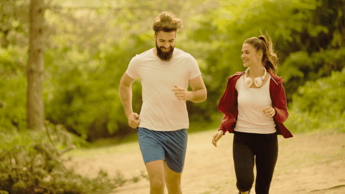 Couple jogging outdoors in nature for exercise